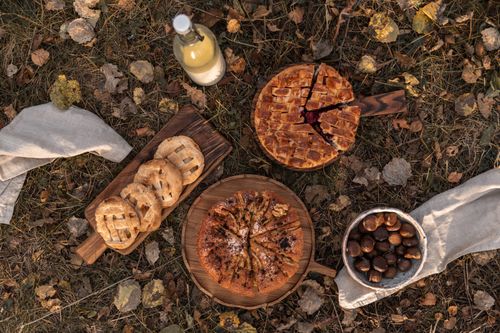 Free Flat lay of pies and chestnuts on autumn leaves, perfect for cozy food moments. Stock Photo