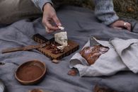 Person Holding Brown Wooden Chopping Board