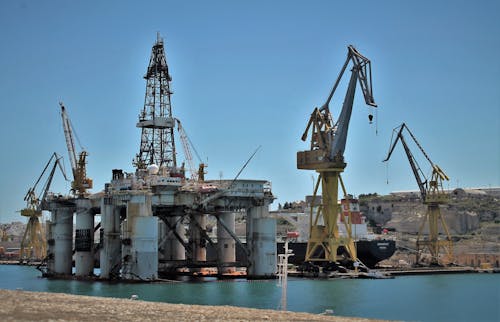 Construction machinery in port against blue sky