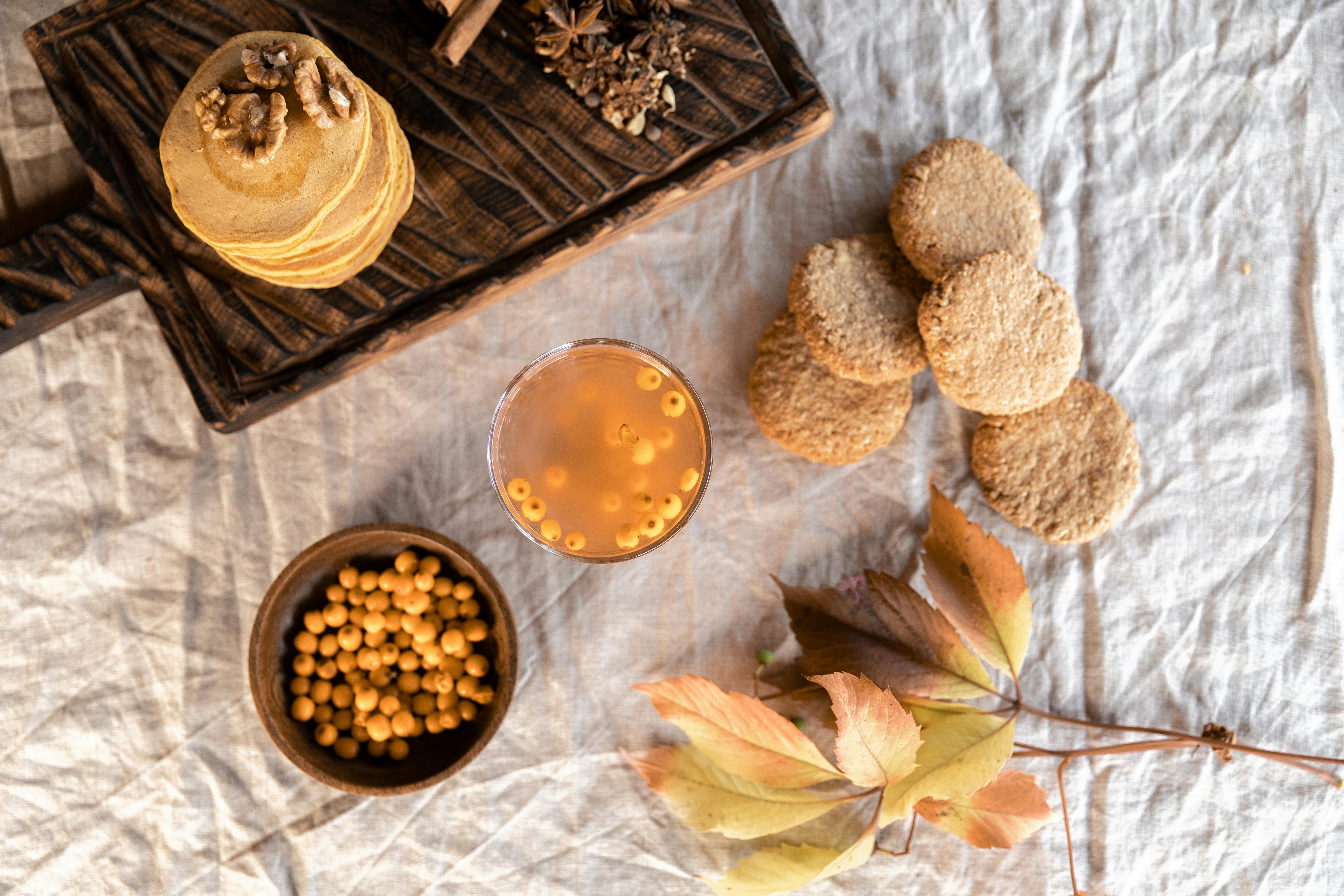 colorful array of unusual superfoods like tiger nuts, jicama, and sea buckthorn on a rustic table