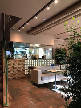 Chic restaurant interior with stylish seating arrangement and ambient lighting.