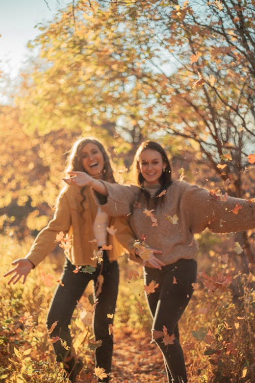 Young Women Playing with Autumn Leaves 