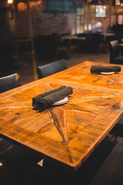 Wooden cafe table with napkins