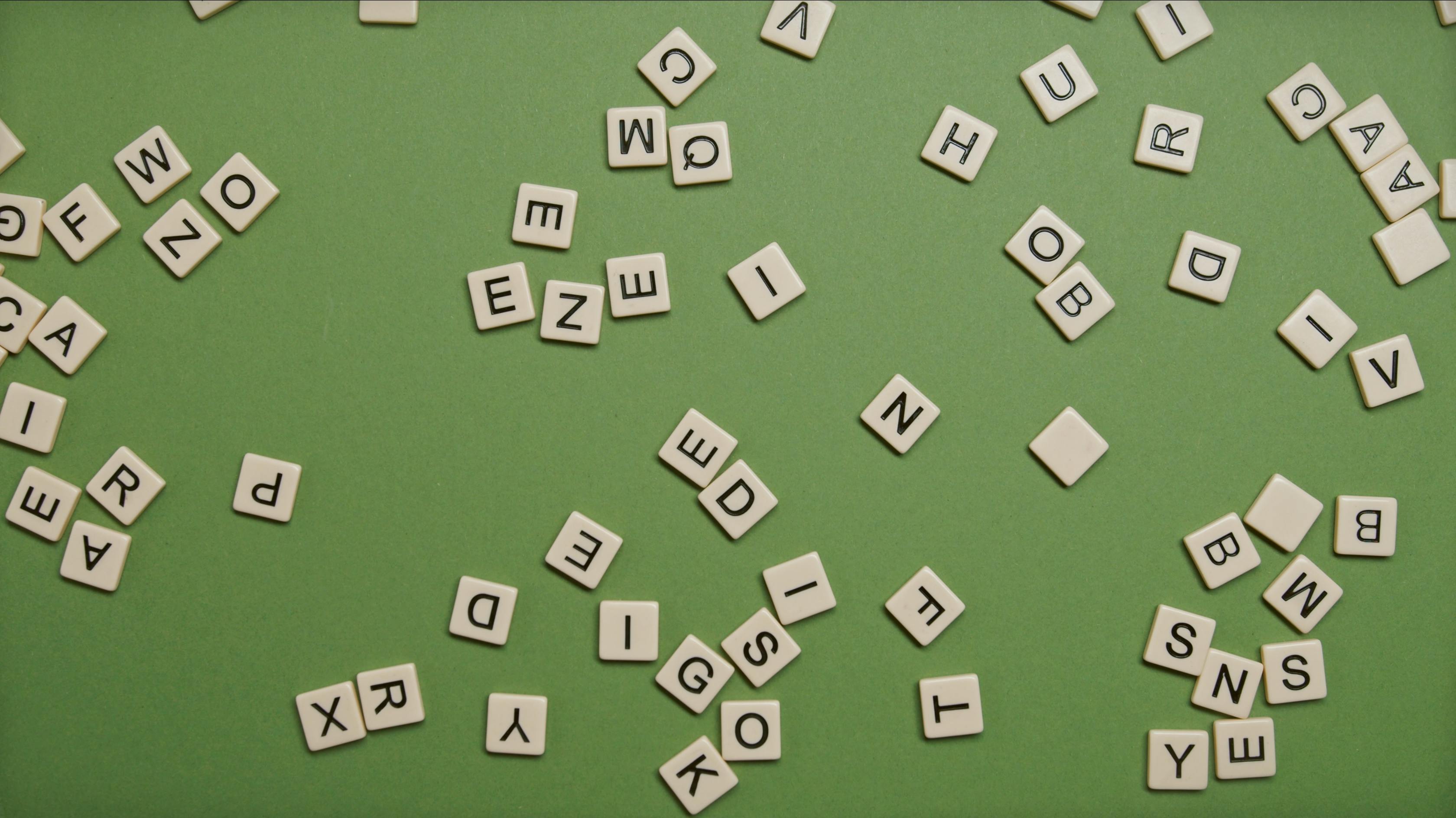 square blocks with letters on green surface