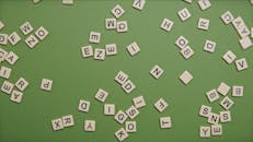 Square Blocks With Letters on Green Surface