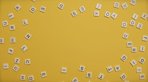Scattered Letters on Yellow Surface