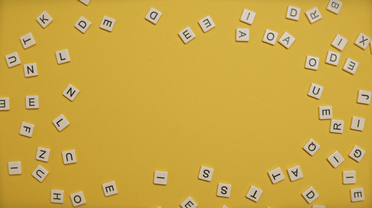 Scatter Letters Scattered Letters on Yellow Surface · Free Stock Photo