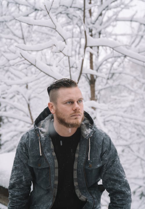 Brutal man standing in heavy snowfall