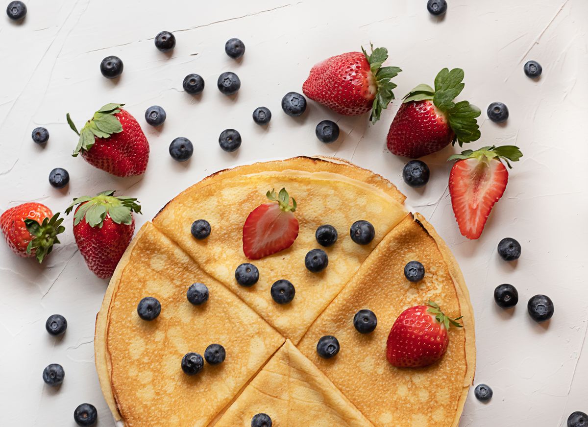 Thin golden crepe cut into wedges and topped with fresh blueberries and strawberries
