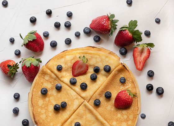 Thin golden crepe cut into wedges and topped with fresh blueberries and strawberries