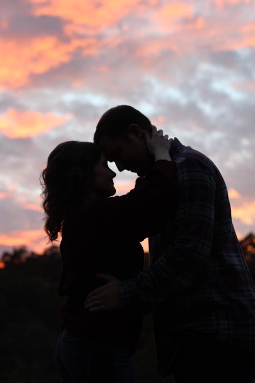 Man and Woman Embracing during Sunset · Free Stock Photo