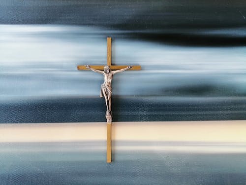 Free A Crucifix over Denim Looking Surface Stock Photo