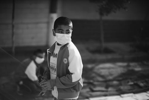 Grayscale Photo of Boy Wearing Face Mask