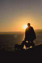 Silhouette of Man and Dog on Beach during Sunset