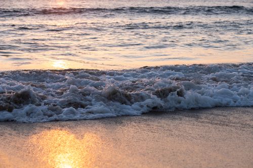 Free Foamy waves crashing on the shore at sunset, Redondo Beach, CA. Stock Photo