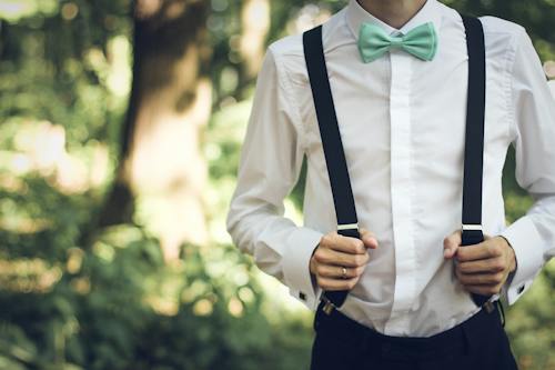 Free Person Holding Black Suspenders Stock Photo
