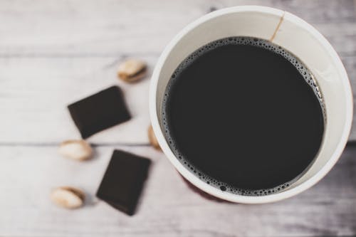 White Styro Cup on Brown Wooden Surface