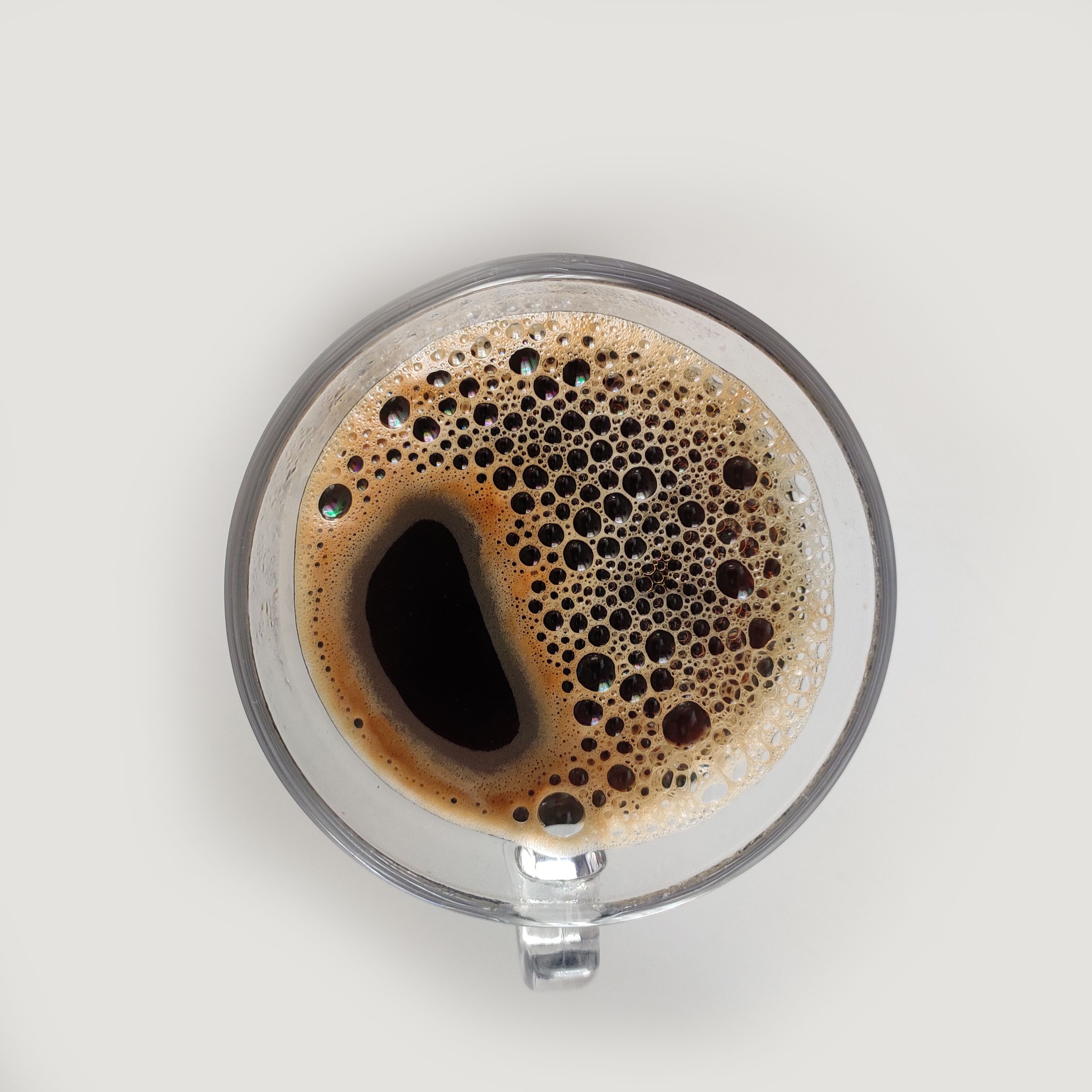 Overhead view of black coffee in a glass mug — photo by Yashasvi Nagda on Pexels
