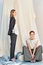 Woman in White Shirt and Black Blazer Sitting on Bed