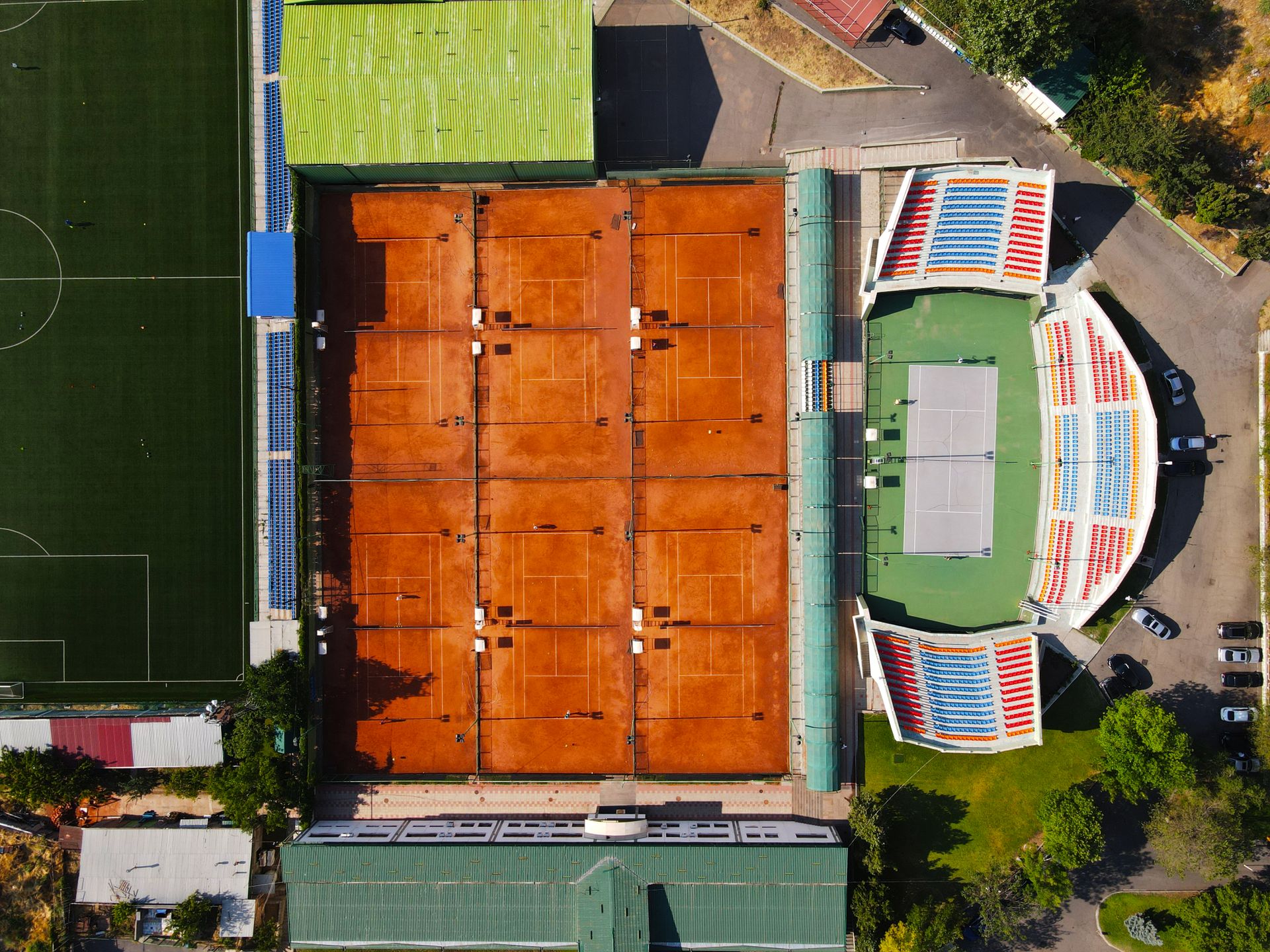 Clay court and exterior view of Roland-Garros in Paris during daytime
