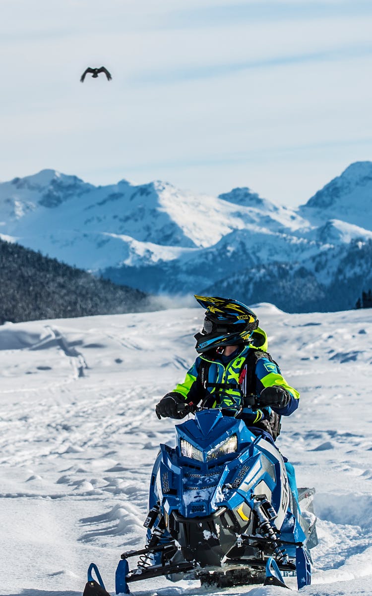 Person Riding Snowmobile