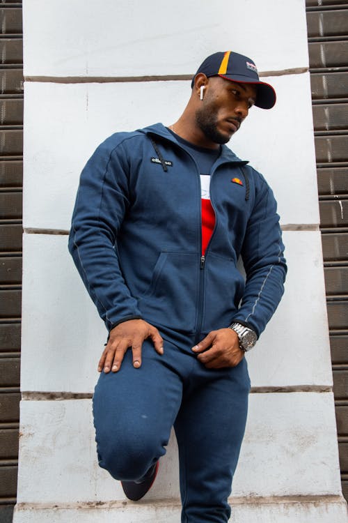 Man in Blue Jacket leaning on Wall 