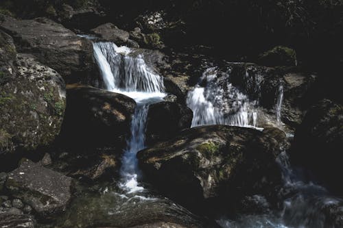 Waterfalls with fast water fluids on rocky surface