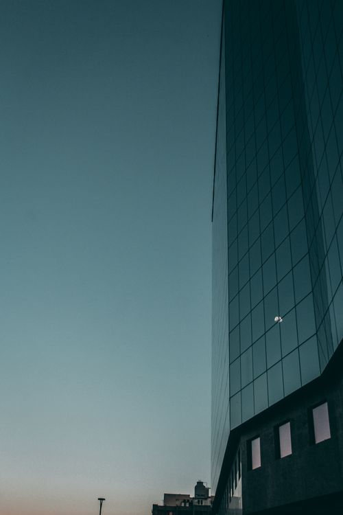 Free A towering glass skyscraper in Rio de Janeiro against a twilight sky, capturing urban elegance. Stock Photo