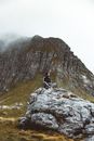 Man sitting on a Boulder