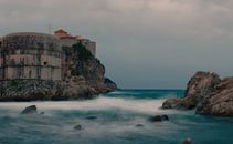 Fortification on cliff washed by azure seawater
