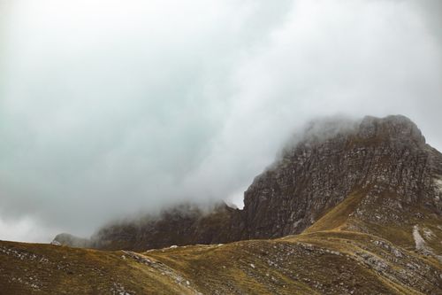Free A breathtaking view of a misty mountain landscape enveloped in fog and clouds. Stock Photo