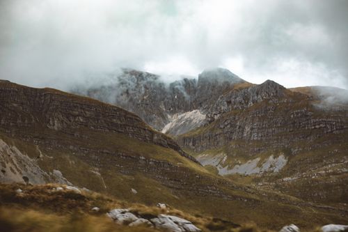Free Dramatic mist covered rocky mountain landscape with a hazy atmosphere. Stock Photo