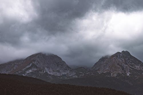 Free Rock Mountains surrounded by Fog Stock Photo