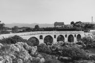 Grayscale Photo of Bridge over River