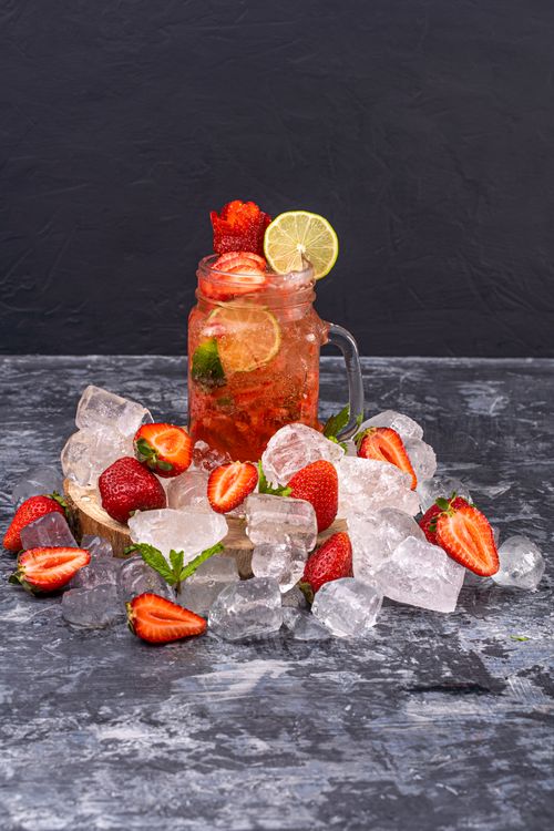 Free Delicious strawberry lime mocktail surrounded by ice cubes, perfect for summer refreshment. Stock Photo