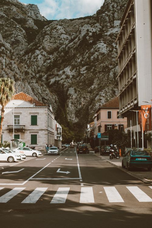 Free Charming street view in mountain town with pedestrians walking by historic buildings. Stock Photo