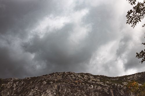 Free Gloomy skies cast shadows over rugged rock formations, exemplifying geological beauty. Stock Photo
