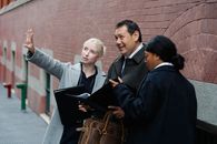 Young businesswoman explaining project to ethnic partners