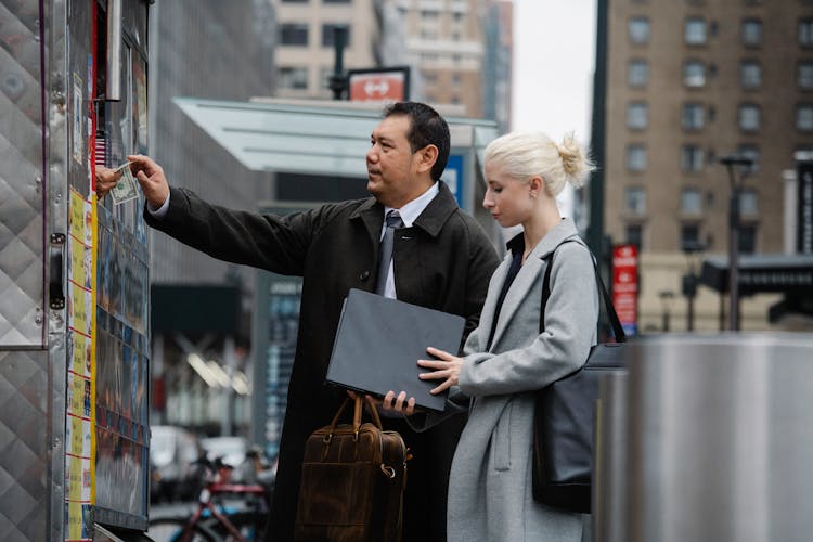 Multiracial Colleagues Buying Takeaway Beverage From Booth On Street