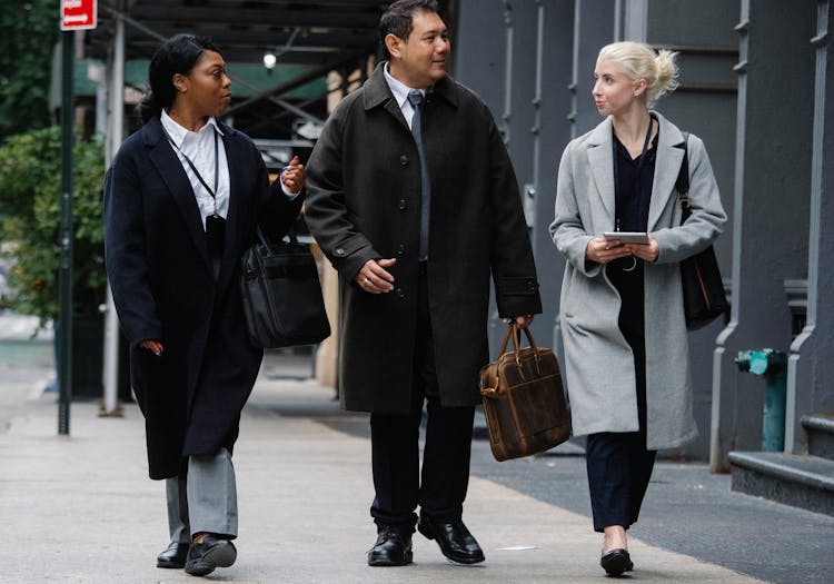 Stylish Diverse Businesspeople Walking On Street