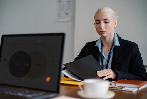 Free Stock Photo of Businesswoman working on laptop in office