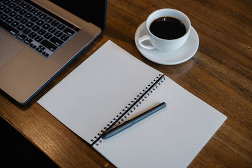 Free Laptop and notepad near cup of coffee Stock Photo