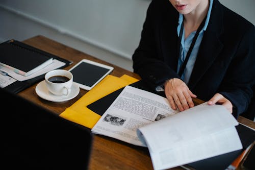 Crop woman working with documents in workspace