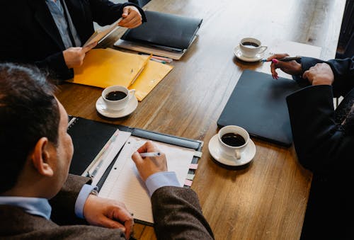 Crop colleagues working together in office