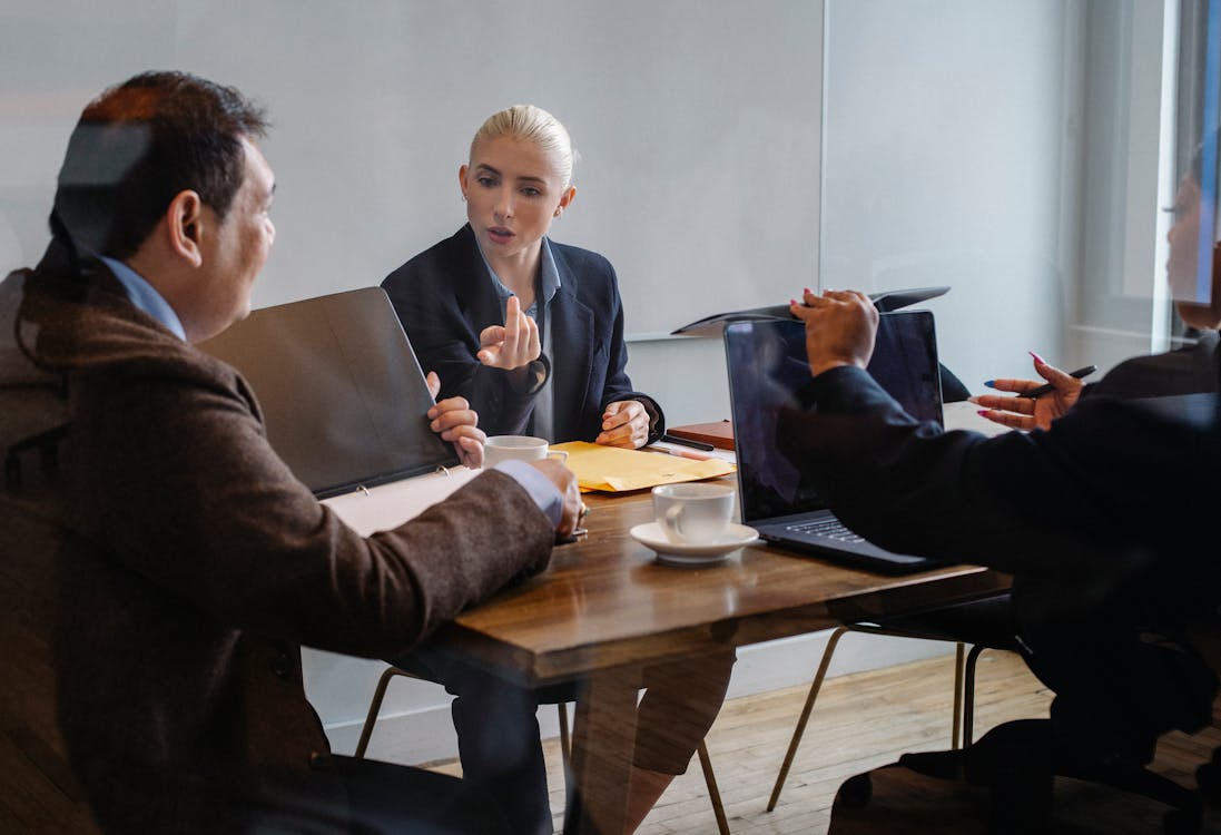 Free Serious colleagues discussing business project in office Stock Photo