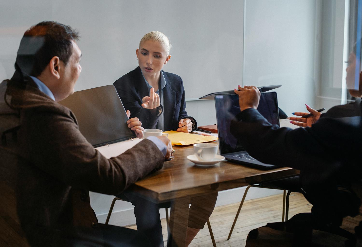 A diverse group of professionals collaborating during a business meeting in an office setting.
