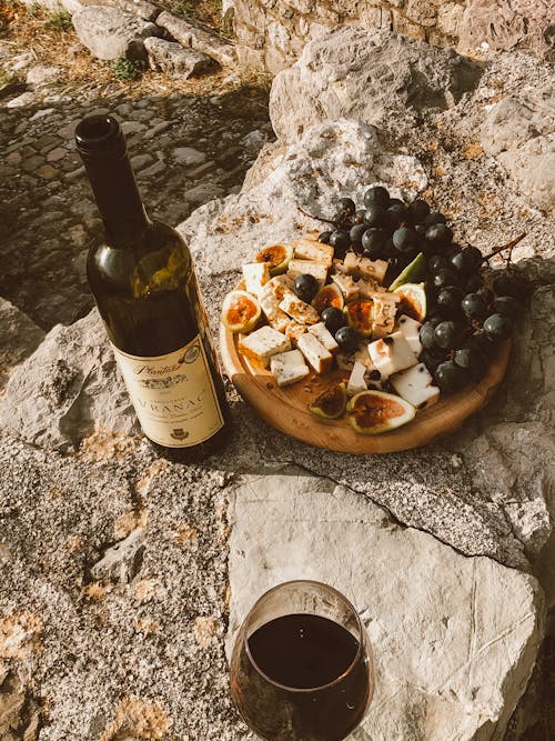 Free Cheese Platter and Wine Bottle on a Boulder  Stock Photo