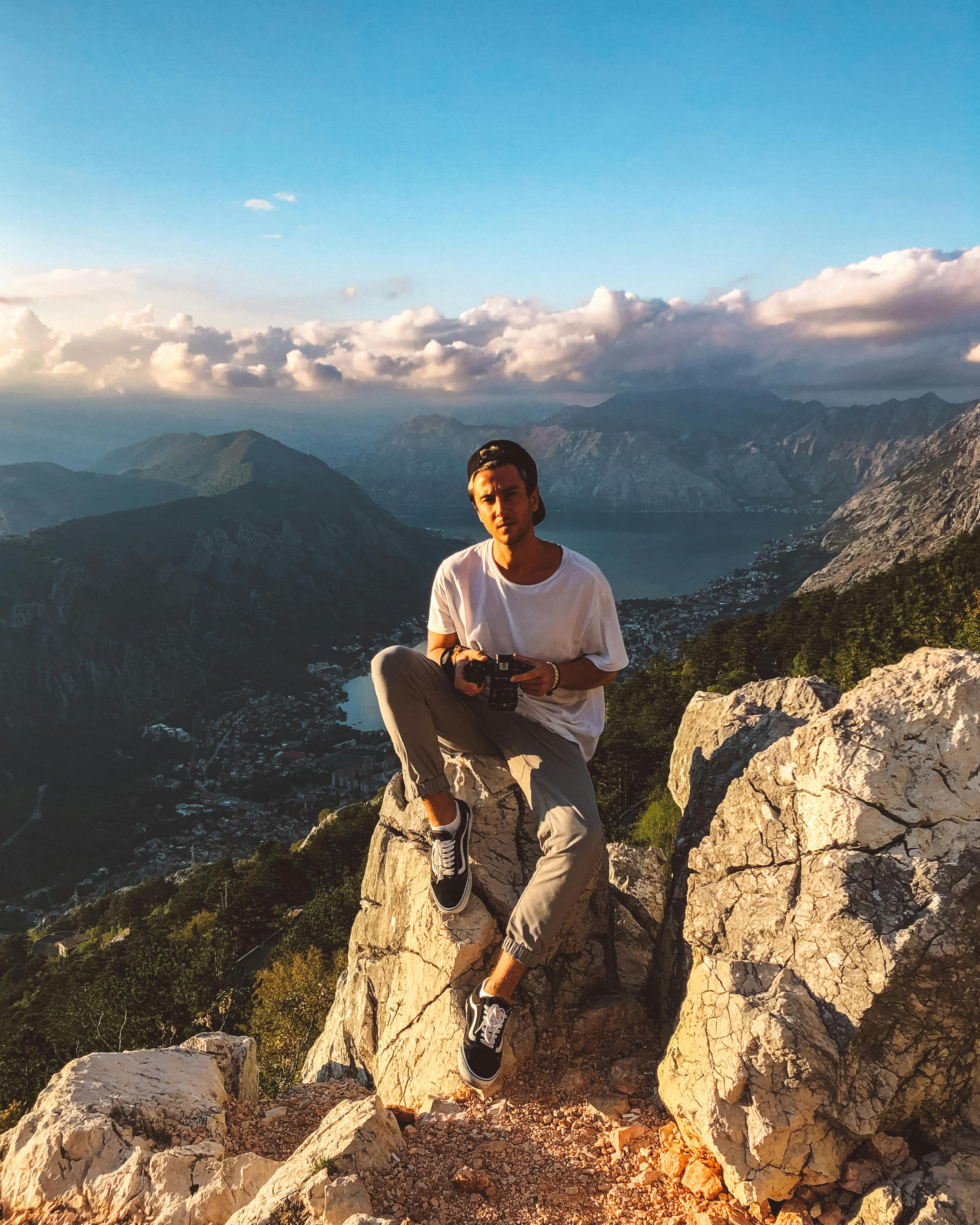 男人穿着休闲装，欣赏壮丽山景，拥抱大自然的美丽