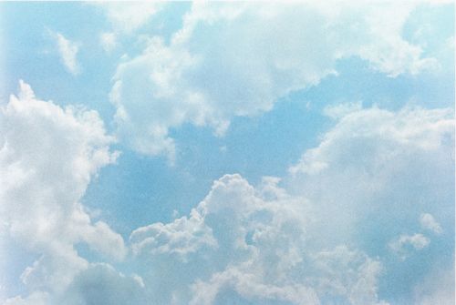 Free Peaceful view of a clear blue sky dotted with fluffy white clouds. Stock Photo