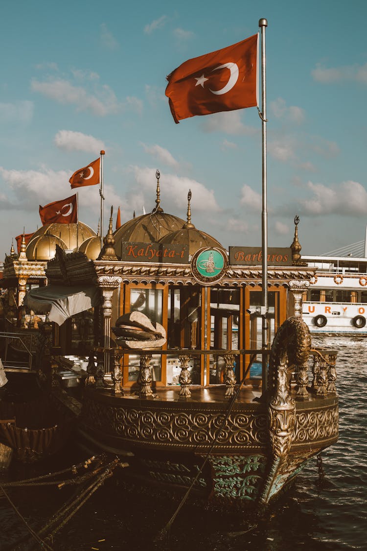 A Flag On An Intricate Boat At Sea 